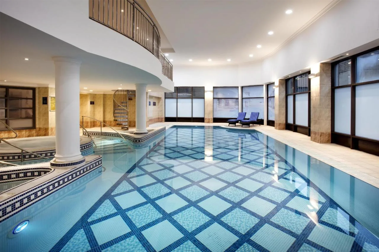 Indoor swimming pool with blue tiles at the Cambridge Street hotel in Glasgow City Centre