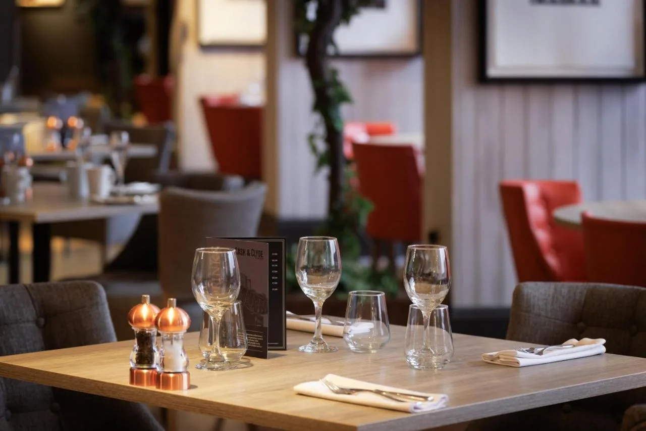 Restaurant table set with wine glasses at DoubleTree Glasgow